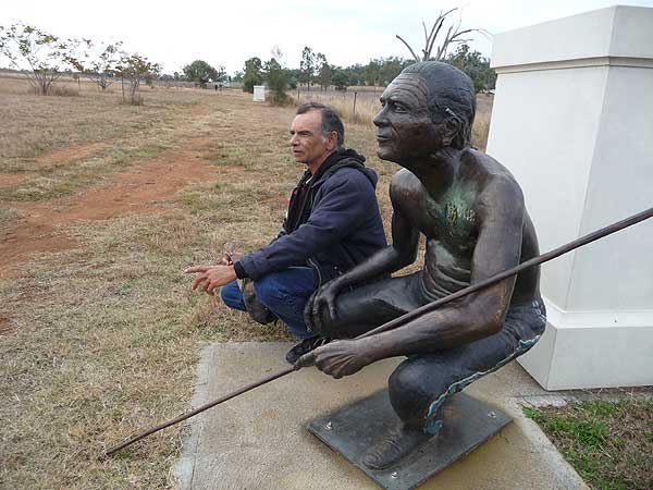 Koori Artist, Colin Isaacs, with his staute on the Parade of Heroes.